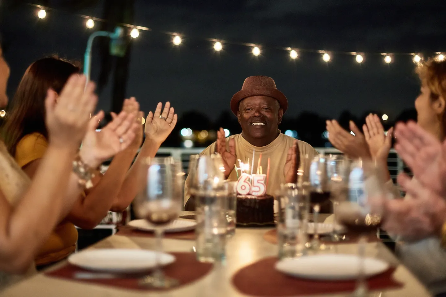 A group of people sitting at a table with wine glasses.